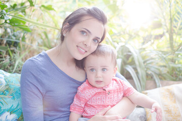 Fototapeta premium Mother holding baby girl outdoors