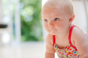 Baby girl crawling on floor