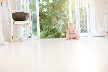 Obraz na płótnie Canvas Baby girl crawling on floor