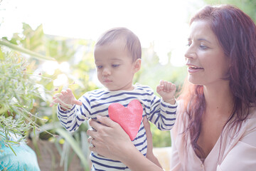 Mother holding baby girl outdoors