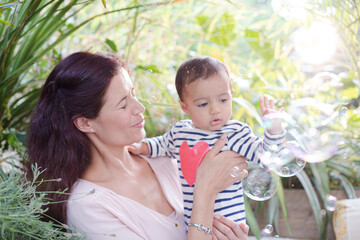 Obraz premium Mother holding daughter outdoors