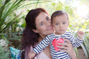 Mother holding daughter outdoors