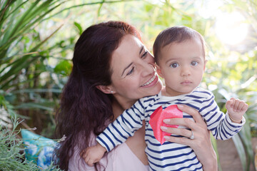 Mother holding daughter outdoors