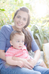 Mother holding baby girl outdoors