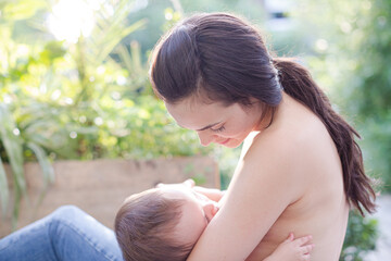 Mother breast-feeding baby boy