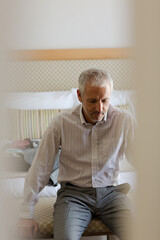 Businessman sitting on bench in hotel room