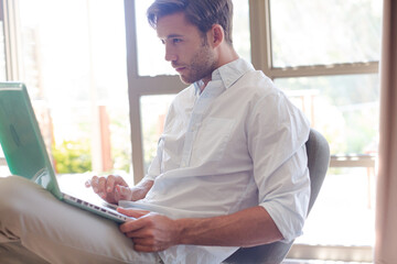 Man using laptop in living room