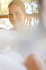 Woman relaxing in bubble bath