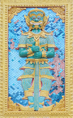 The high-relief sculpture of a giant on the temple wall thai style at Sri Don Mun Temple, Chiang Mai, Thailand