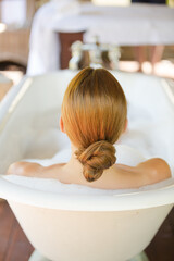Woman relaxing in bubble bath