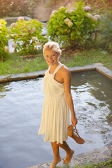 Woman walking by edge of pool