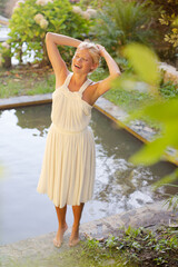 Woman stretching by pool outdoors