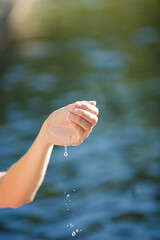 Woman dipping her hand in pool