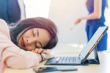 business woman work from home sleeping on the workplace and feel tired after working on tablet computer, Lifestyle woman relax after working at home concept. depressed businesswoman