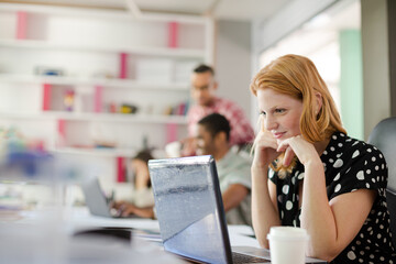 Woman working at laptop in office
