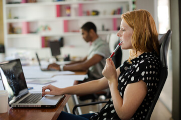 Woman working at laptop in office