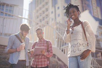 Woman talking on cell phone on city street