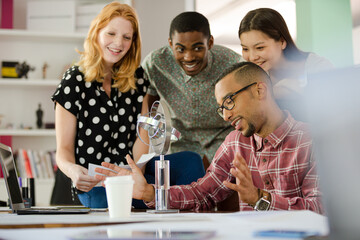 People examining model in office