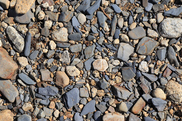 River pebbles on the river bank, Magadan region, Russian Far East. Gravel texture background