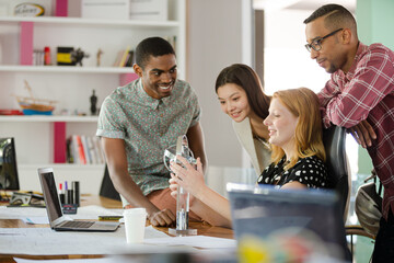 People examining model in office