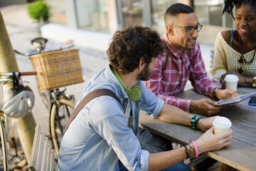 Friends talking at sidewalk cafe