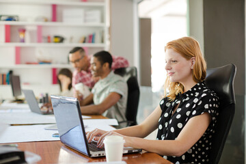 Woman working at laptop in office