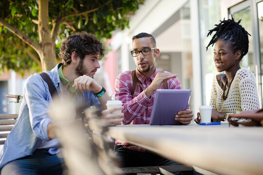 Friends talking at sidewalk cafe