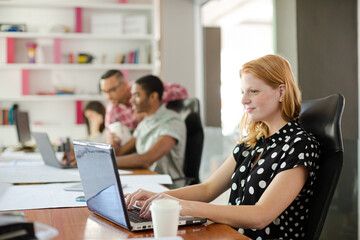 Woman working at laptop in office