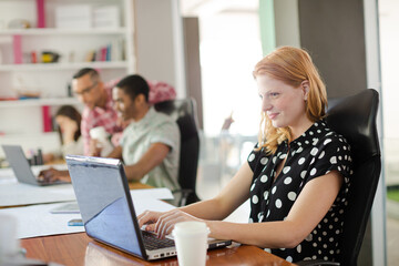 Woman working at laptop in office