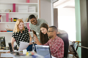 People examining model in office