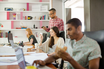 Man eating and working at conference tablet