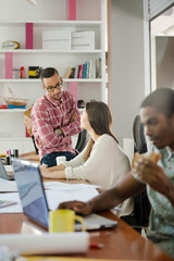 Man eating and working at conference tablet