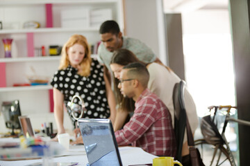 People examining model in office
