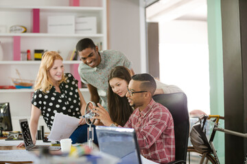 People examining model in office