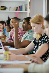 People working at conference table in office