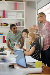 People examining model in office