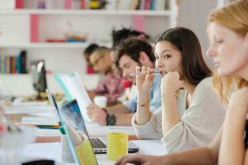 People working at conference table in office