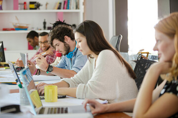 People working at conference table in office