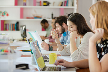 People working at conference table in office