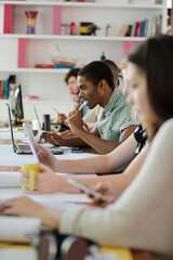 People working at conference table in office
