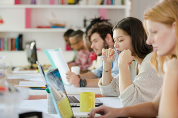 People working at conference table in office