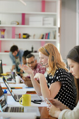People working at conference table in office