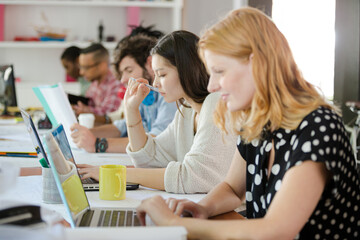 People working at conference table in office