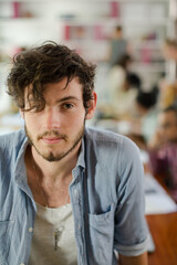 Man leaning on desk in office