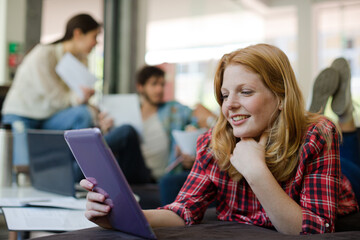 Woman using digital tablet in cafe