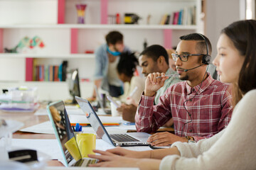 People working at conference table in office
