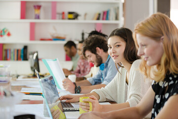People working at conference table in office