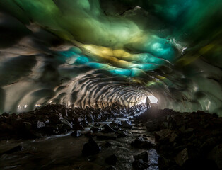 snow cave with a multi-colored ceiling with yellow, blue, green, white inserts, a silhouette of a...