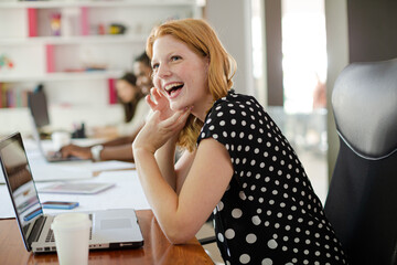 Woman working at laptop in office