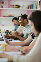 People working at conference table in office